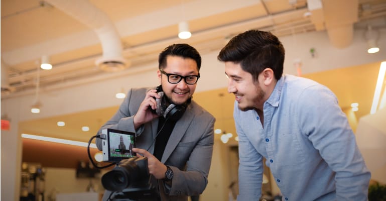 Two men looking at a camera