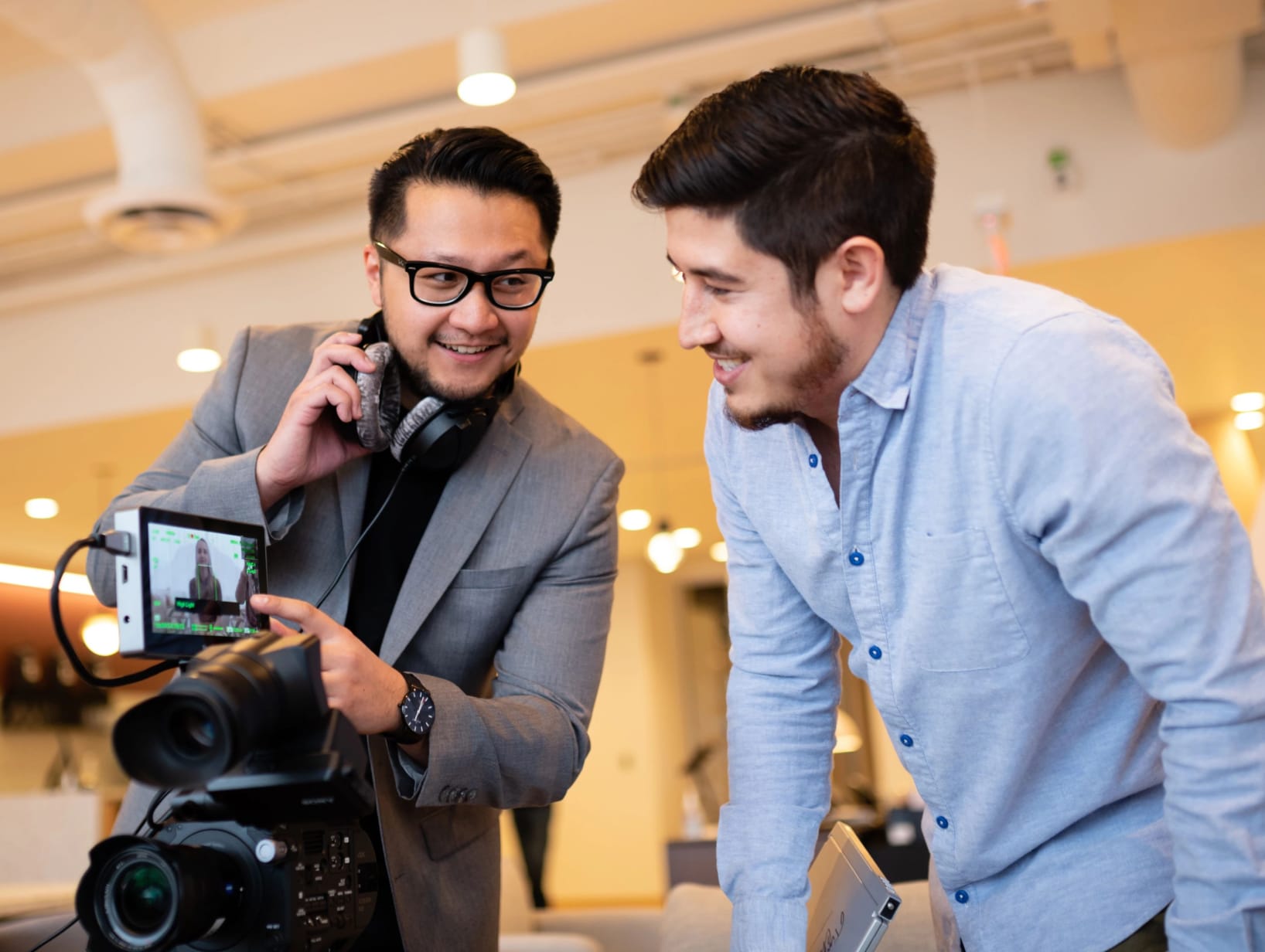 Two men looking at a camera