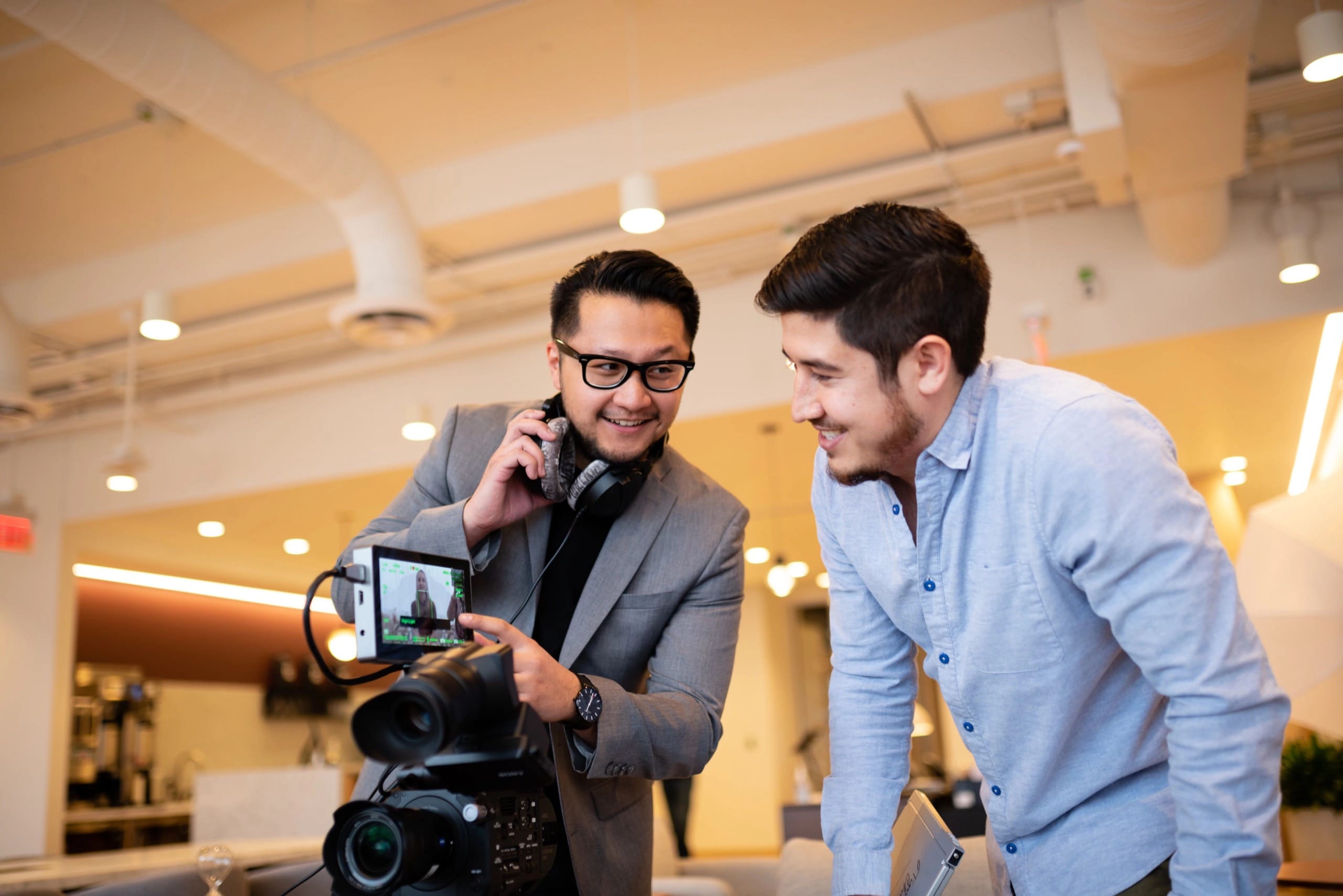 Two men looking at a camera