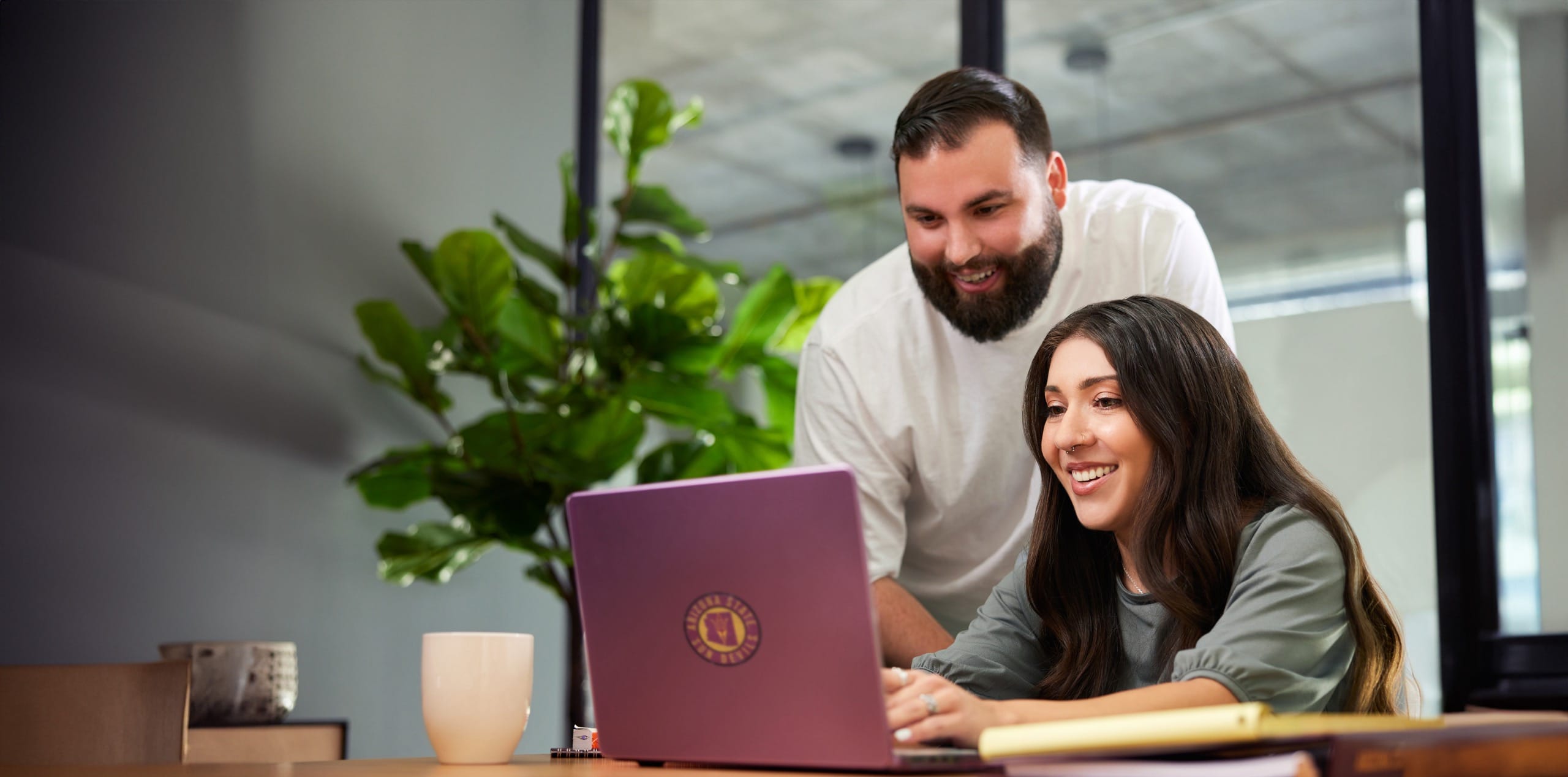 Man and woman looking at laptop