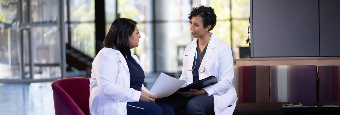 Two medical professionals sitting with papers