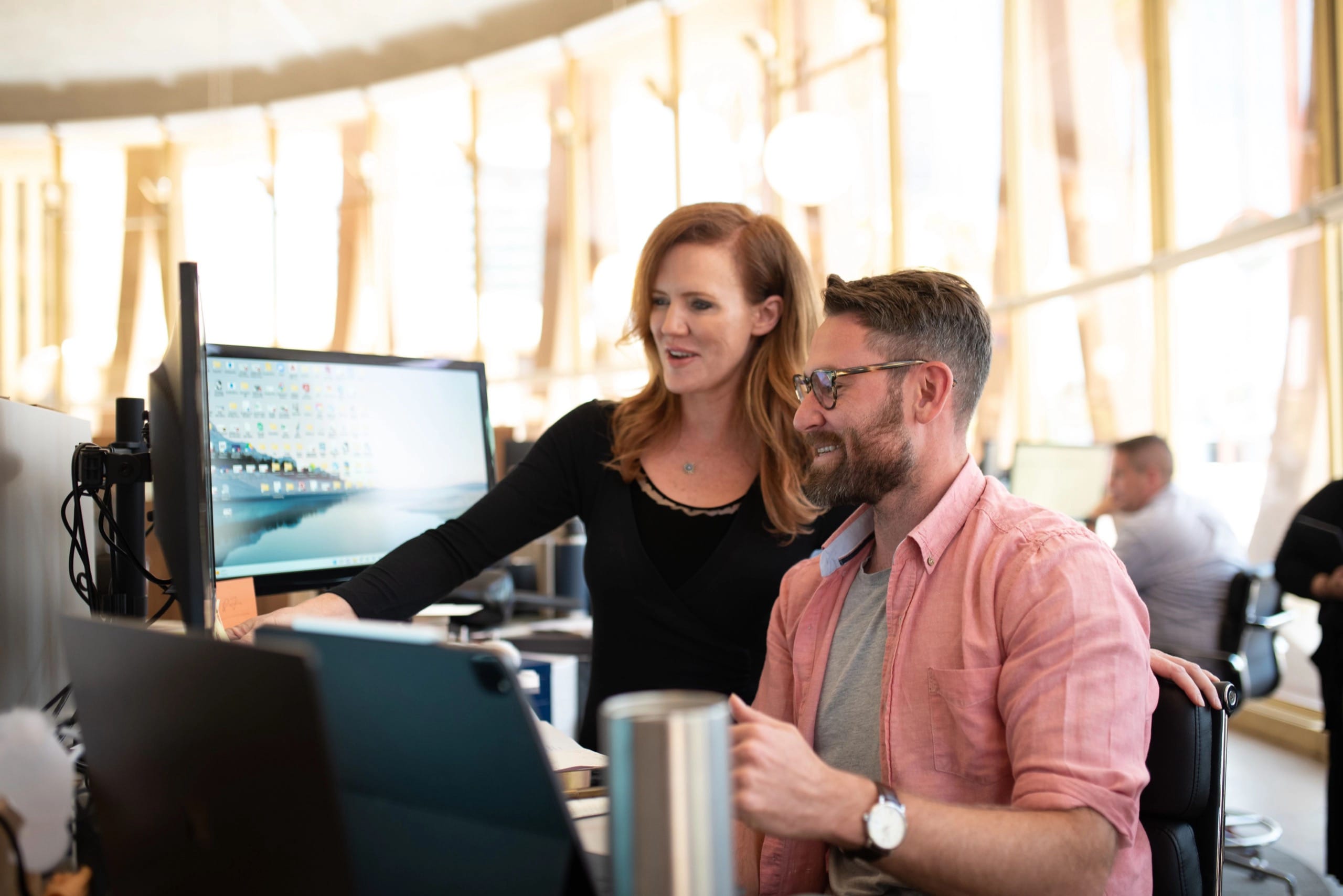 Woman looking at a man's computer