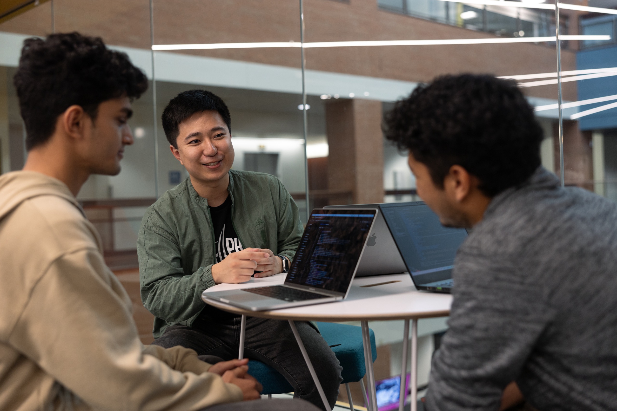 Three men working with laptops