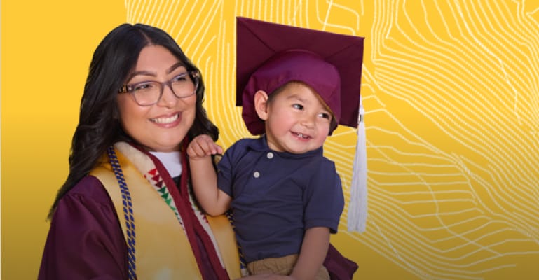 Woman graduating and holding a child