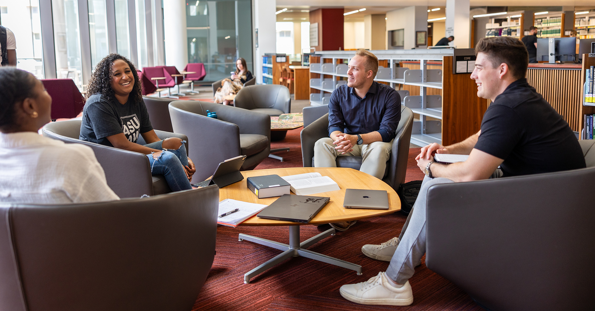 Students sitting and laughing in the library