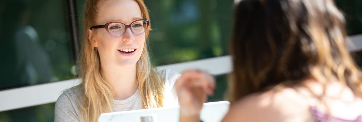 Woman smiling at a person