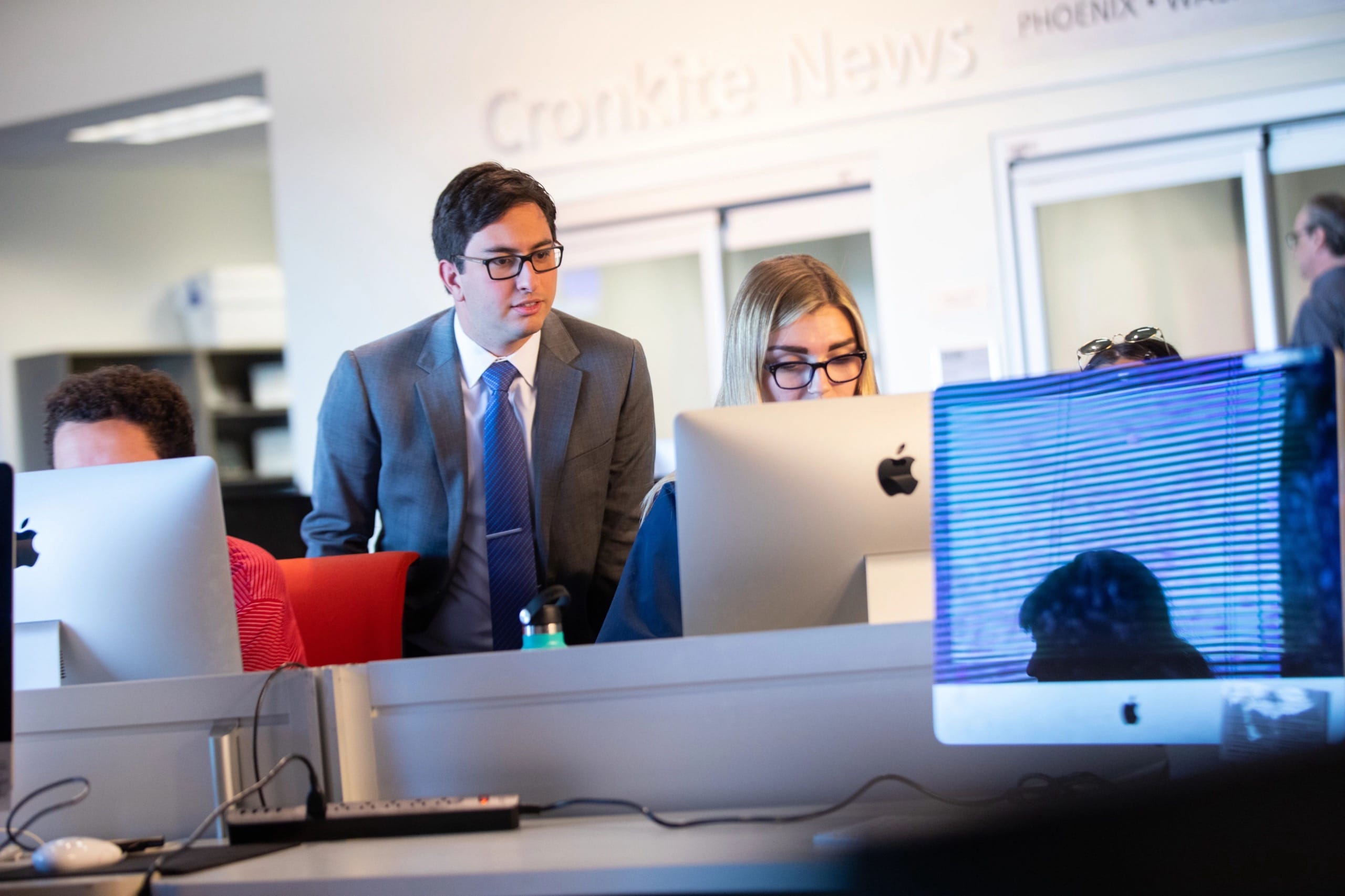 Man looking at a woman's laptop