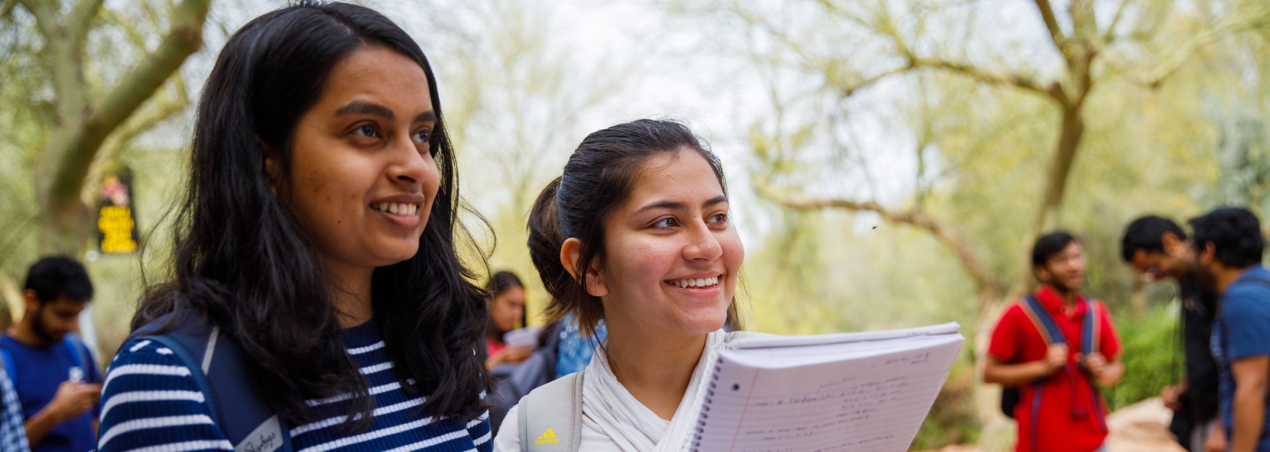 Students standing outside near trees