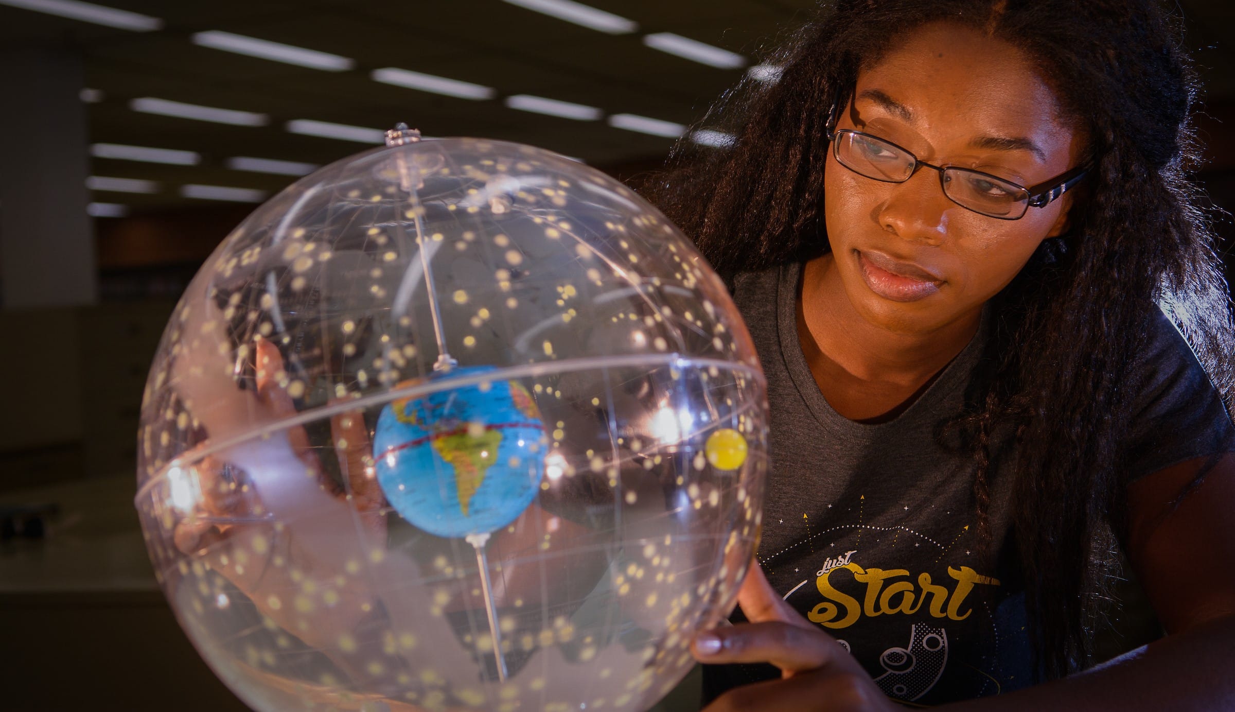 Woman looking at the solar system