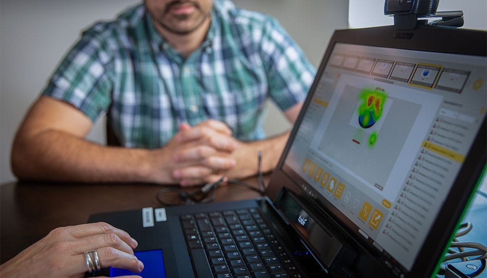 People looking at image on a laptop