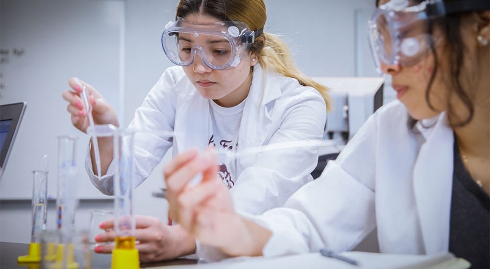 Two women working with pipettes