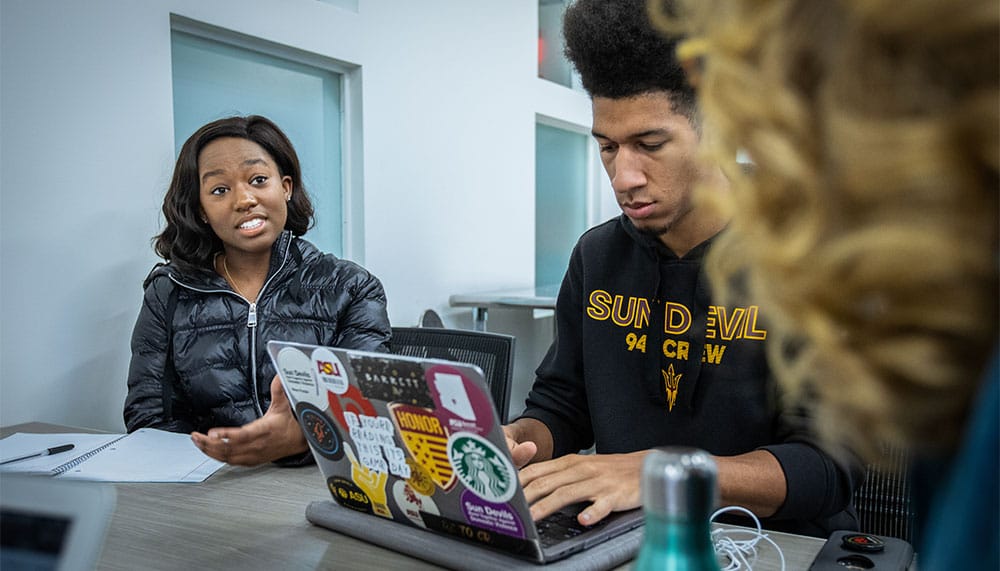 Students talking at a table