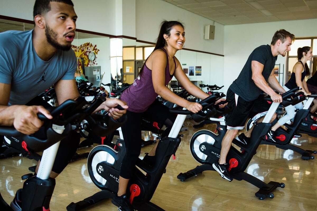 People participating in a cycling class