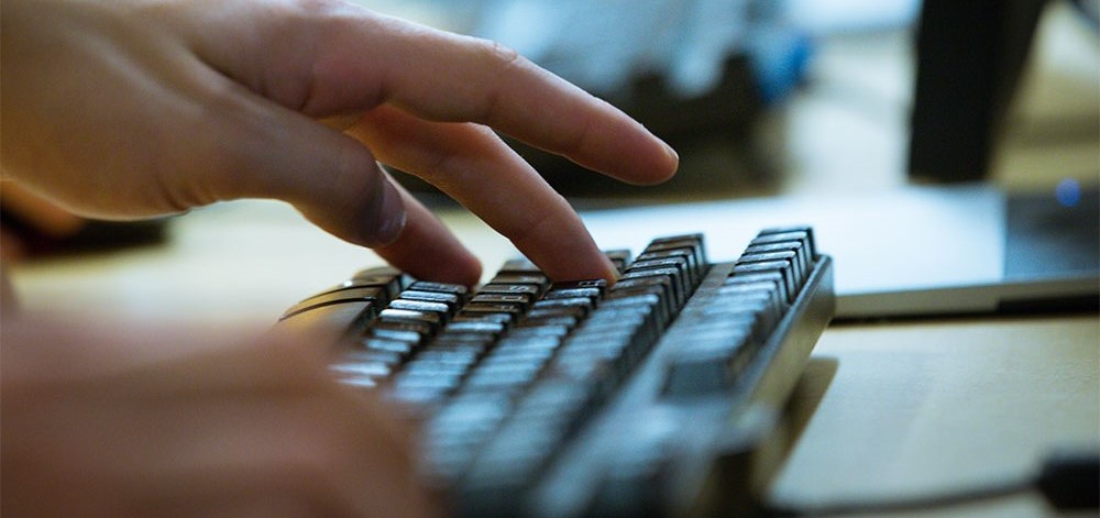 Fingers typing on a keyboard