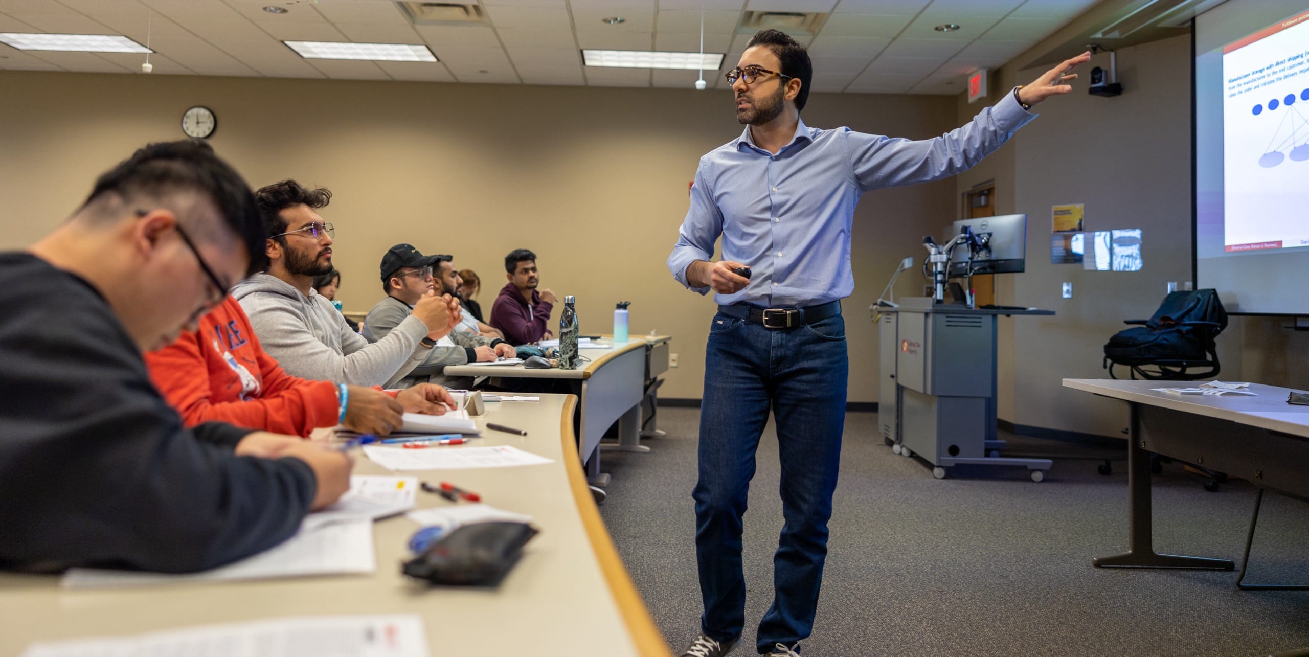 Man lecturing to students in a classroom