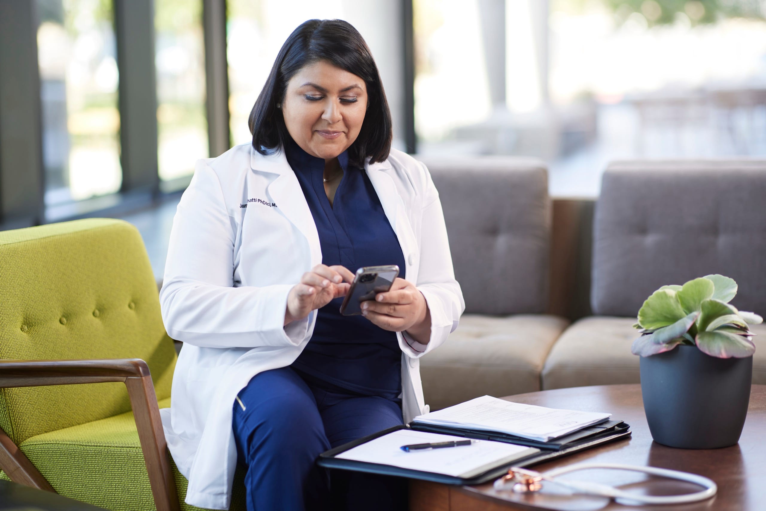 Female doctor looking at phone