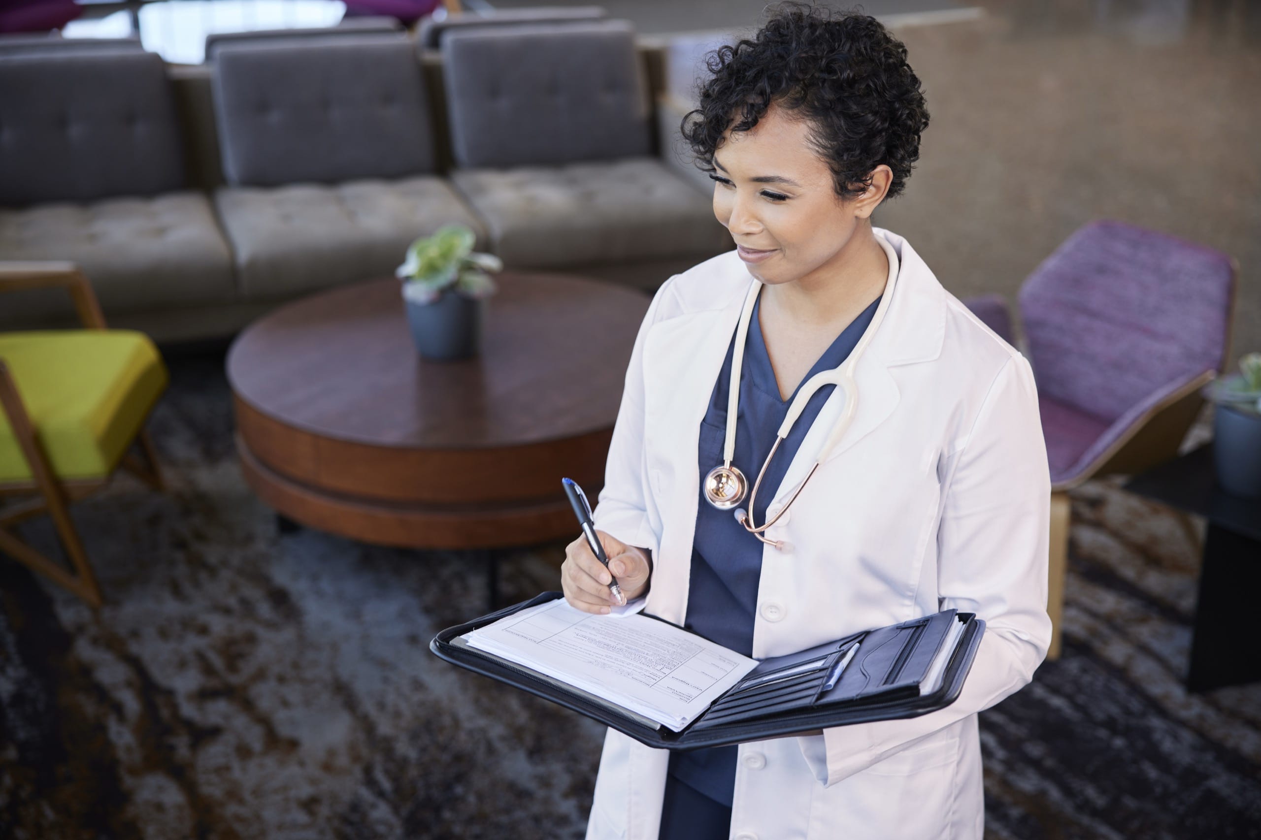 Woman doctor writing in a notebook