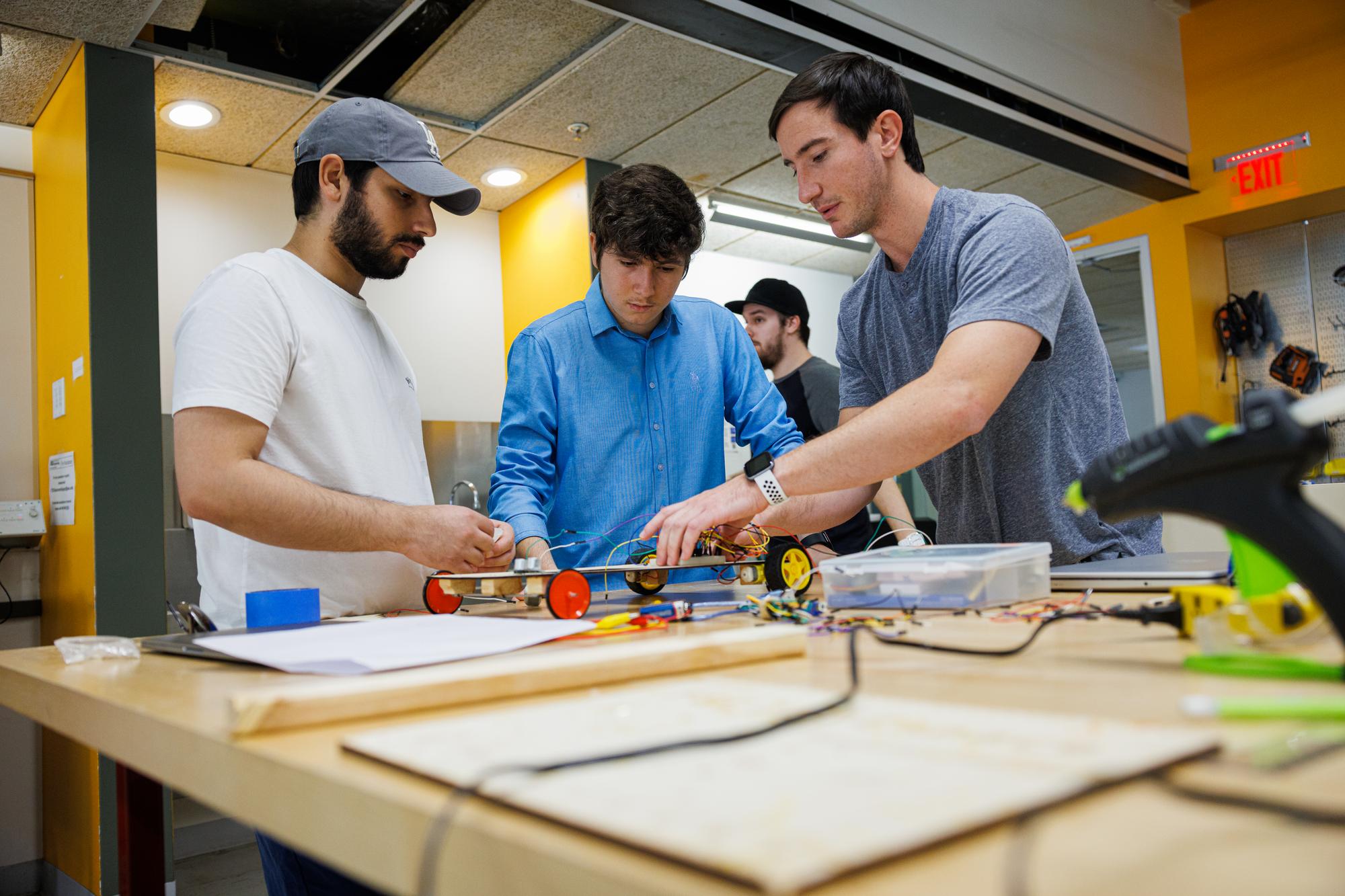 Three men building a machine