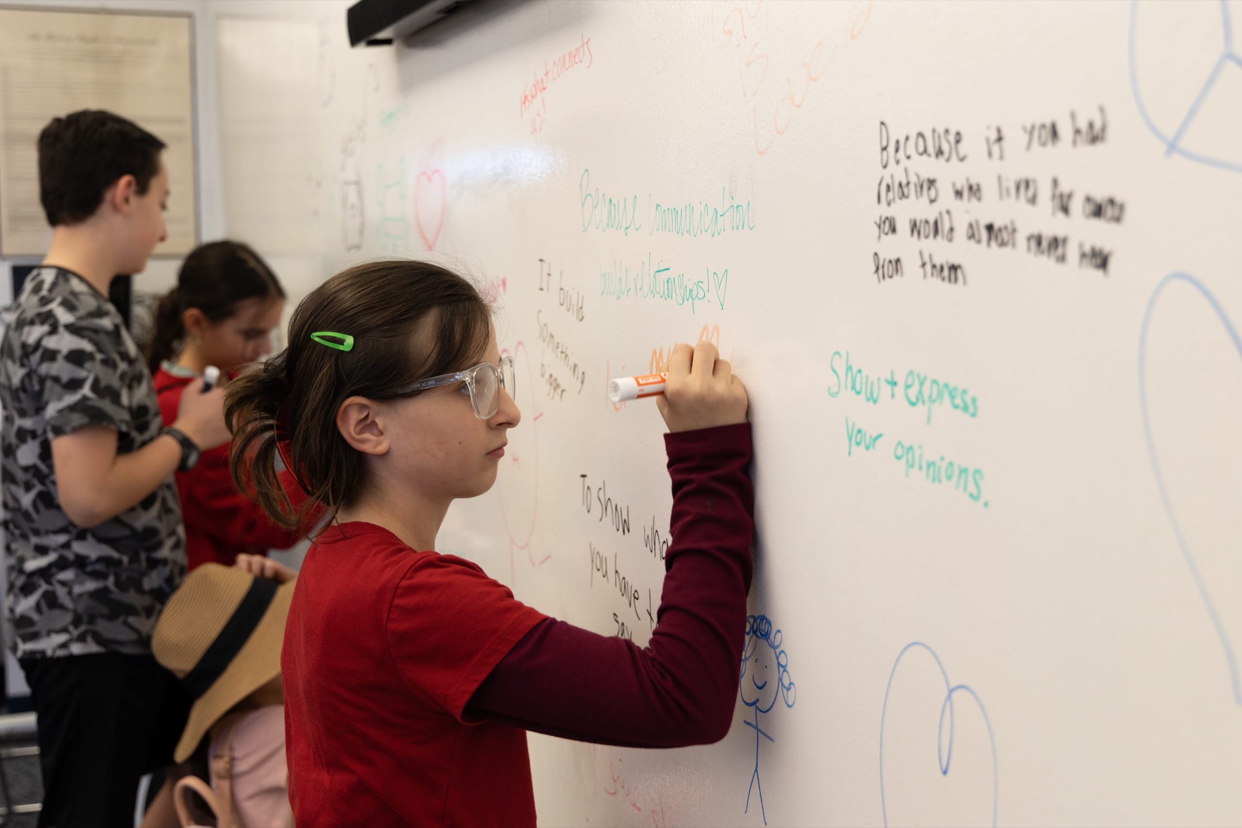 Young students writing on a whiteboard